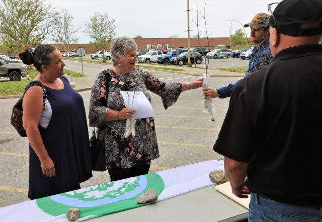 Members of Fort Knox Environmental Management Division distribute three different types of tress to community members for free in celebration of Arbor Day April 29, 2022.
