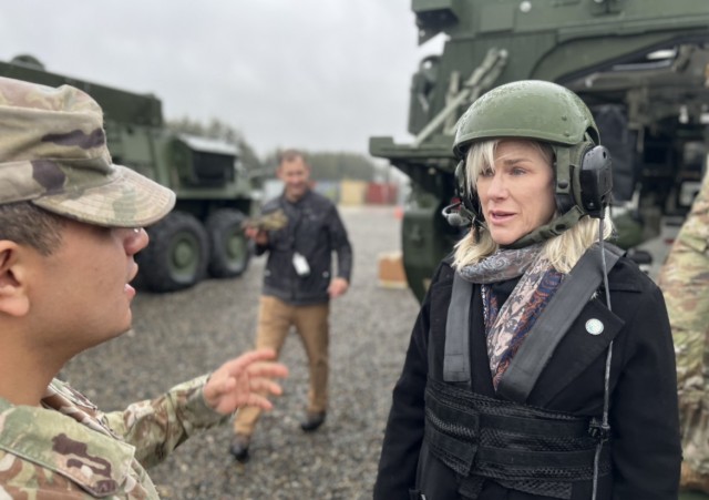 Olympia Mayor Cheryl Selby dons safety gear and discusses safety procedures with Spc. Palaez, an infantry soldier and Stryker driver.