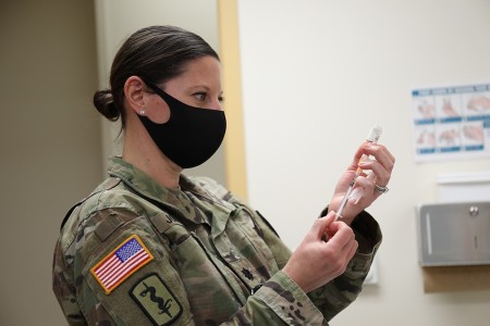 Lt. Col. Natalie Johnson, a reservist, prepares to administer a vaccine on March 1 at the BG Crawford F. Sams U.S. Army Health Clinic on Camp Zama, Japan.