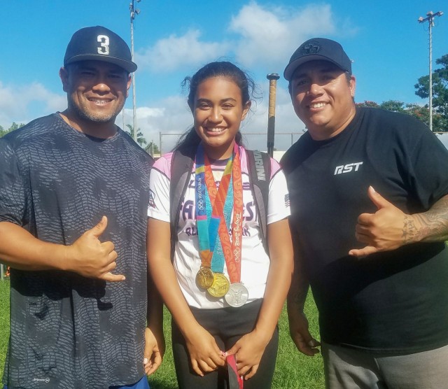 Kekua Aumua, left, a supervisory air traffic control specialist at Camp Zama, Japan, and his daughter, Kierstyn, take a photo with Crystl Bustos, an Olympian softball player who won two gold medals and a silver medal, after she conducted a coaching session on hitting.