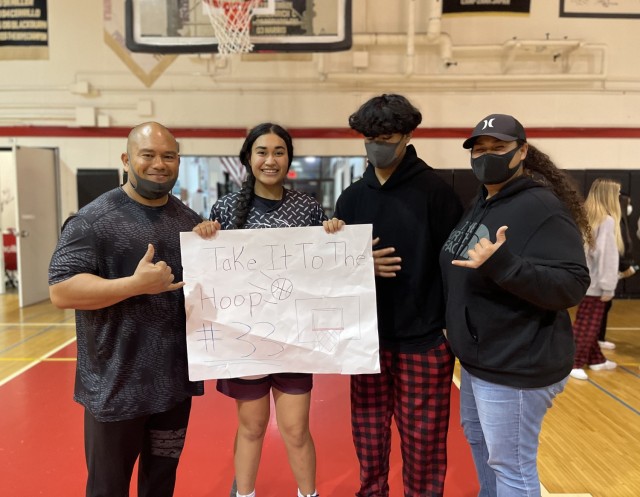 Kekua Aumua, left, a supervisory air traffic control specialist at Camp Zama, Japan, poses for a photo with his family following a basketball game. Aumua often volunteers to coach youth sports as part of his efforts to help the community.
