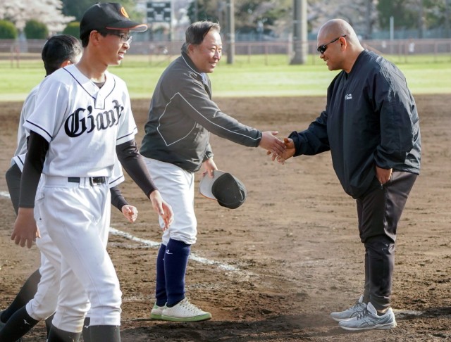Kekua Aumua, right, a supervisory air traffic control specialist at Kastner Airfield, shakes hands with a coach from the Sagamihara Young Giants baseball team at Camp Zama, Japan. Aumua helped organize the team, which his two children were on, so...