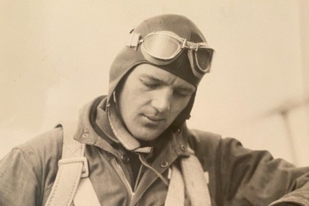 Lt. Col. Addison E. Baker, prepares a flight log circa 1944