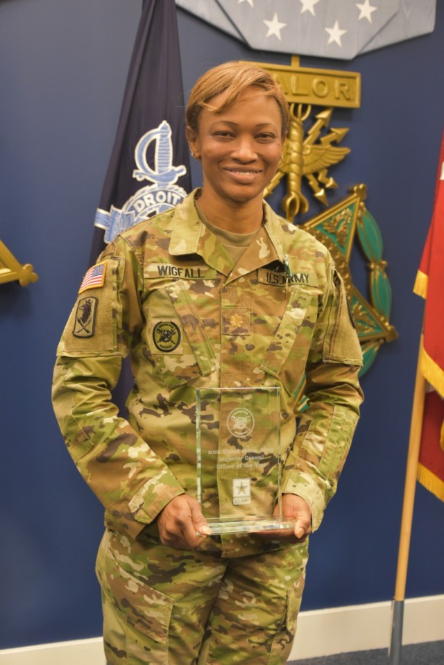 U.S. Army Maj. Nicole Wigfall, the deputy inspector general of Network Enterprise and Technology Command at Fort Huachuca, Arizona, holds her award after being named the Army Inspector General of the Year in the officer category at the Pentagon in Arlington, Virginia, April 20, 2022. 

