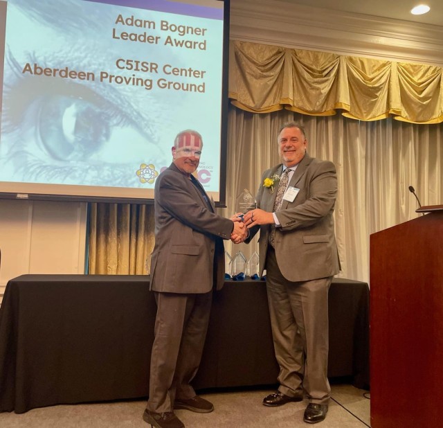 Adam Bogner, the division chief of the DEVCOM C5ISR Center’s Engineering and Systems Integration directorate, receives the Leader Award from Northeastern Maryland Technology Council’s executive director John Casner during the 11th NMTC Visionary Awards Gala April 20.