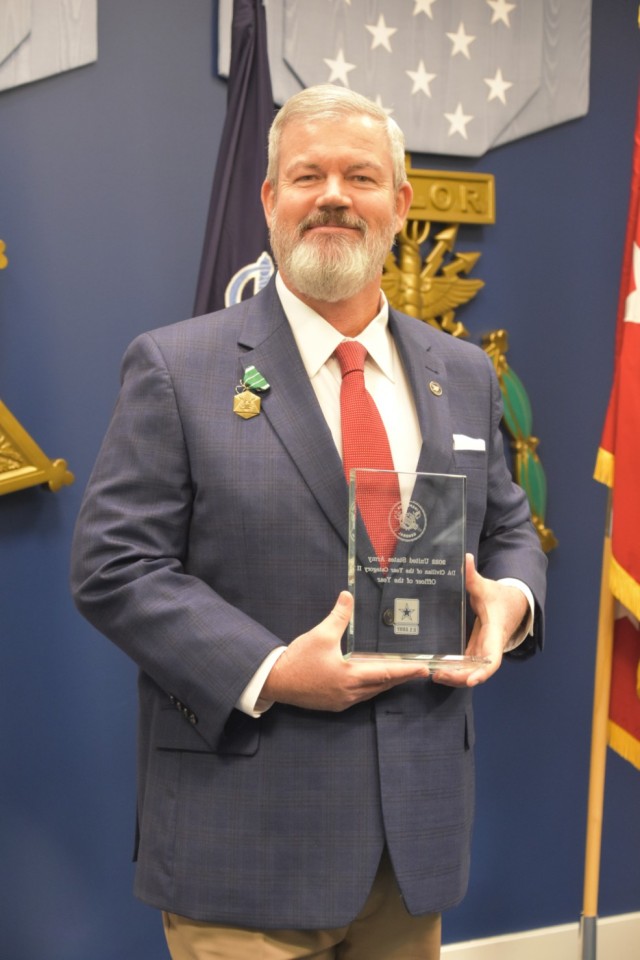 Christopher Cummings, an inspector general with Army Futures Command in Austin, Texas, holds his award after being named the Army Inspector General of the Year in the GS-12/13 category at the Pentagon in Arlington, Virginia, April 20, 2022. 