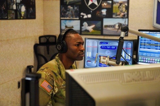 U.S. Army Staff Sgt. Julius D. Harris, Armed Forces Network Radio Host during his radio interview with the 1st Theater Signal Brigade Sexual Assault Coordinator, Master Sgt. Wilson D. Ramirez at the AFN Radio Station in Camp Humphreys, South Korea on April 11, 2022.