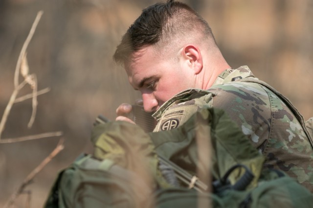 A U.S. Army Paratrooper assigned to 1st Brigade Combat Team, 82nd Airborne Division talks into a radio microphone during rotation 21-05 at the Joint Readiness Training Center on Fort Polk, La., March 7, 2021. The rotation serves to enhance the brigade and their supporting unit's deployment readiness. (U.S. Army photo by Sgt. Justin Stafford)