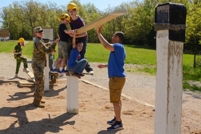 Staff Sgt. Salvador Serrano, a drill sergeant with Company B, 31st Engineer Battalion, assists family members in executing the Team Development Course at Training Area 137 during the Drill Sergeant for a Day event May 7. 