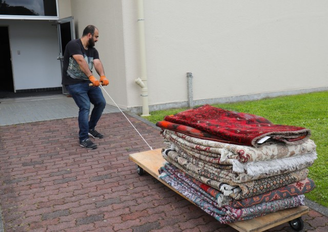 A vendor for Fiza Carpet pulls a load of rugs into the Camp Zama Community Club in Japan, May 12, 2022. The club will hold its spring bazaar May 14 from 9 a.m. to 5 p.m. and May 15 from 10 a.m. to 4 p.m. It will offer customers a variety of items from antiques, furniture, jewelry, toys, carpets, paintings to trinkets and other Japanese souvenirs that can add flair to a home or be mailed back to family and friends.
