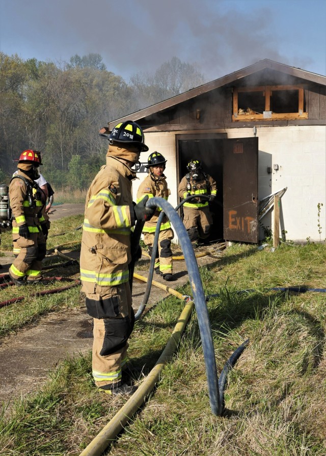 Fort Knox Middle High School seniors participating in the 150-hour firefighter certification program take part in a multi-department structure fire training April 27, 2022.