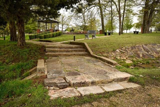 Stonework constructed by prisoners of war housed at Fort Leonard Wood during World War II lines the walkway and culvert surrounding the Military Police Memorial Grove. The stonework is eligible for the National Register of Historic Places. 