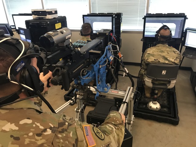 U.S. Army Soldiers use a Reconfigurable Virtual Collective Trainer system to conduct training.