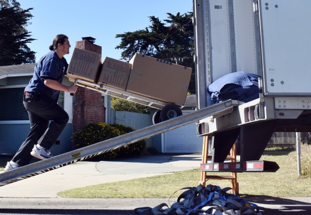 Movers load a service member’s household goods into a moving truck at a residence in Pacific Grove, Calif., May 11. 