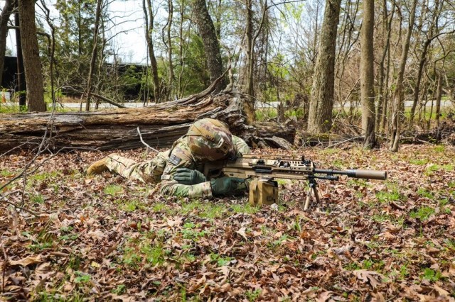 A Soldier looks down the sights of the new XM250 light machine gun. the XM250, which is about four pounds lighter than the M249, are still in their prototype phase and may change slightly by the time it is out for mass production. 