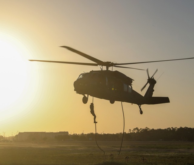 A U.S. special operations service member descends from a UH-60 Black Hawk during Fast Rope Insertion and Extraction System training at Gulfport Combat Readiness Training Center, Gulfport, Mississippi, April 22, 2022. The training was during Southern Strike 2022, a large-scale, joint and international combat exercise.
