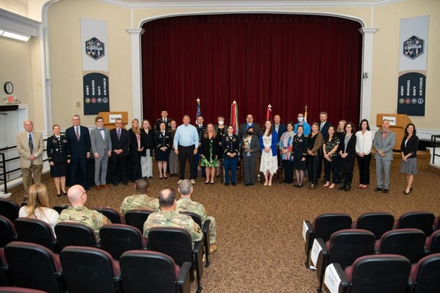 Current and former Army Public Health Center COVID-19 Task Force members pose with the 2021 Army Medicine Annual Wolf Pack award following a ceremony held at the Aberdeen Proving Ground, Maryland, Conference Center April 21, 2022. The Wolf Pack award, which is sponsored by the Army Medical Command Civilian Corps, recognizes exceptional teamwork by an integrated group of Army Medicine civilians and military team members focused on excellence in support of Army Medicine, and was presented to the Army Public Health Center COVID-19 Task Force for outstanding meritorious service during the period of March 13, 2020 to March 31, 2021. 