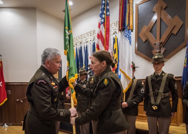 Brig. Gen. Niave Knell, the 51st commandant and chief of the MP Corps, hands the U.S. Army Military Police School guidon to Maj. Gen. James Bonner, Maneuver Support Center of Excellence and Fort Leonard Wood commanding general, during a change-of-commandant ceremony May 13 at Lincoln Hall Auditorium.