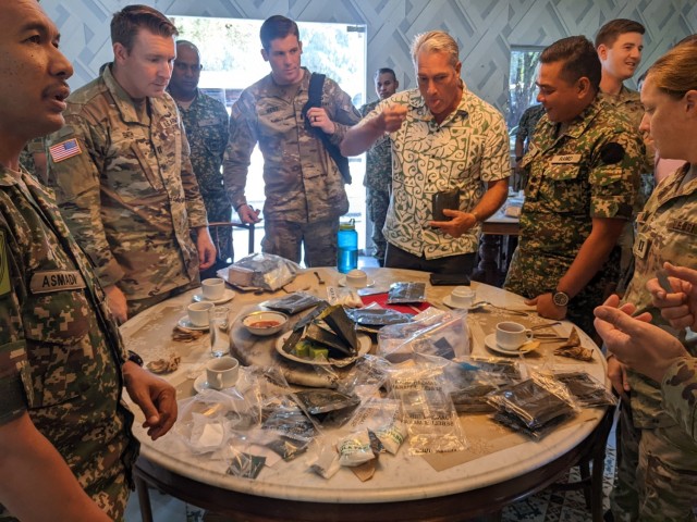 Members of the Malaysian Armed Forces and United States Army perform quality testing of Malaysian MREs.