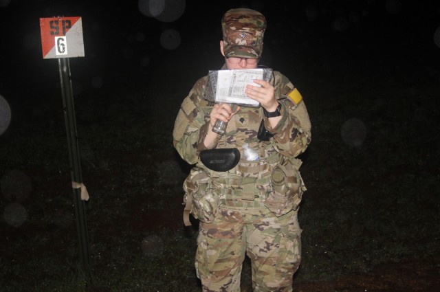 Spc. Chelsey Justice, assigned to Public Health Command-Pacific, searches for a point during the night land navigation portion of the Regional Health Command-Pacific Best Leader Competition, Schofield Barracks, Hawaii, May 9, 2022.