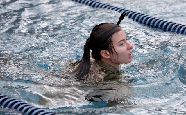 Spc. Polina Gashnikova, assigned to Tripler Army Medical Center, Honolulu, takes part in the water survival event during the Regional Health Command-Pacific Best Leader Competition, May 9, 2022.