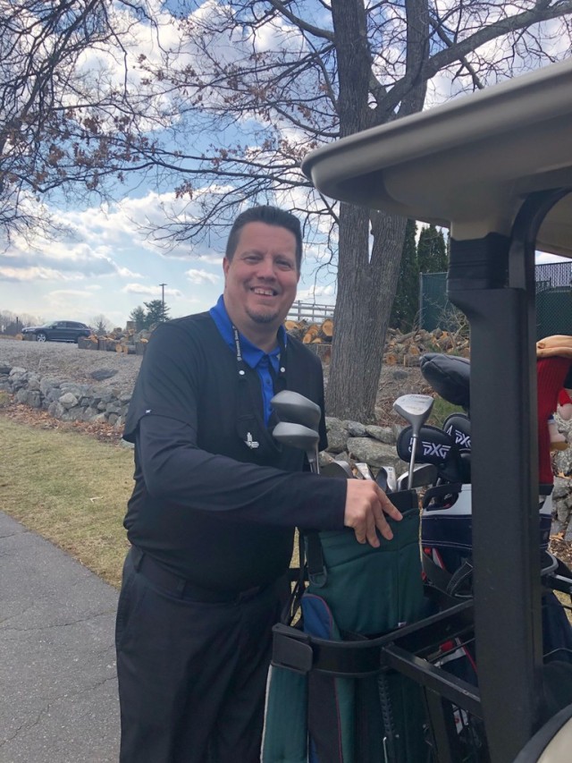 Raymond Santiago, Deputy Garrison Commander, pauses to choose the perfect club for the next tee-up on the golf course, his favorite pastime.