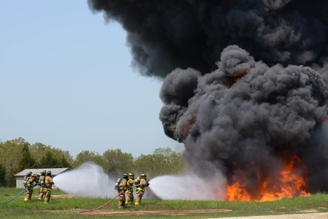 Fort Leonard Wood firefighters work to extinguish a jet fuel fire during a training exercise May 8 at the Aircraft Rescue Firefighting Pit at Training Area 207. 