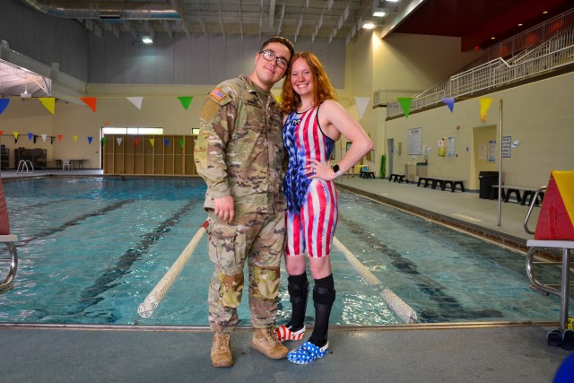 Taylor Winnett (right) poses for a photo Tuesday at Davidson Fitness Center with her husband, Spc. Jeric Winnett, a combat engineer with the 595th Sapper Company. Winnett competed as an able-bodied athlete for 13 years, and had plans to swim in college, until a series of accidents in 2016 changed her life forever. She now competes nationally as a para-swimmer, and set an American record in the S10 classification for the Women’s 50 Backstroke Long Course Meter on May 8 in Cincinnati.