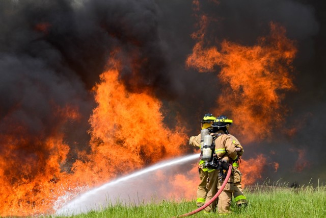 Fort Leonard Wood firefighters work to extinguish a jet fuel fire during a training exercise May 8 at the Aircraft Rescue Firefighting Pit at Training Area 207.