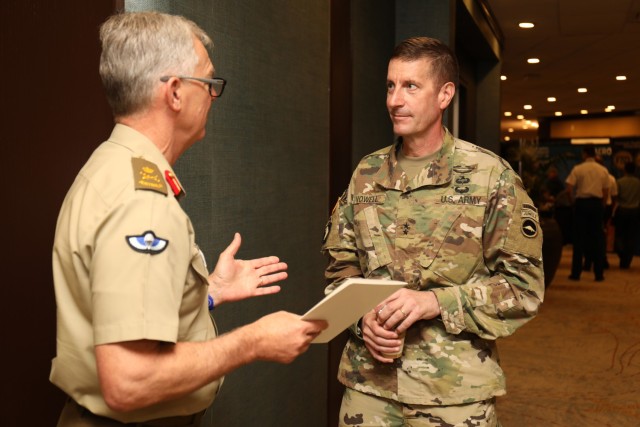 Maj. Gen. JB Vowell, right, commander of U.S. Army Japan, speaks with Lt. Gen. Rick Burr, chief of the Australian Army, during the Land Forces Pacific Symposium in Honolulu May 18, 2022. Senior leaders from the U.S. Army and more than 20 foreign armies held hundreds of bilateral talks during the symposium, the largest land power conference in the Indo-Pacific region.