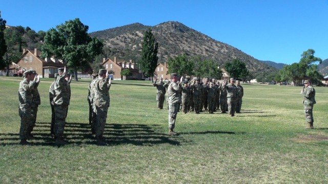 Maj. Gen. Anthony Hale, Commanding General, U.S. Army Intelligence Center of Excellence & Fort Huachuca, leads a group of Soldiers through the Oath of Enlistment during a mass reenlistment ceremony on Brown Parade Field at Fort Huachuca, Ariz.