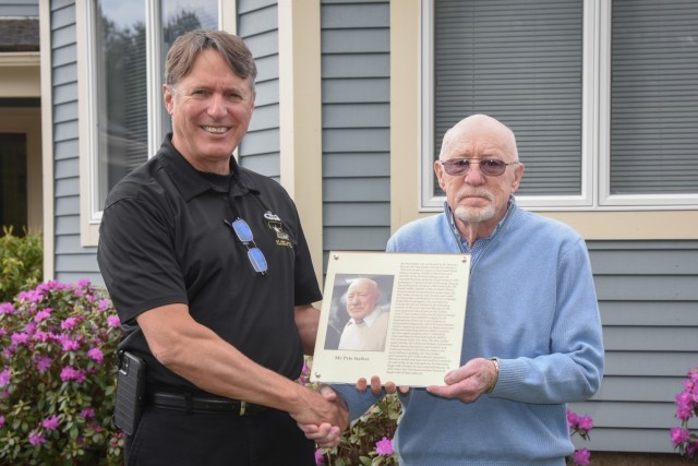 Retired DEVCOM Soldier Center civilian employee Peter Stalker holds his official plaque while posing with his former boss, Richard Benney, after a presentation held at Stalker&#39;s home on April 27 in Massachusetts to honor Stalker&#39;s recent induction into the U.S. Army Quartermaster School Parachute Riggers Hall of Fame. Benny nominated Stalker for the prestigious award while serving as Director of SC&#39;s Aerial Delivery Directorate.