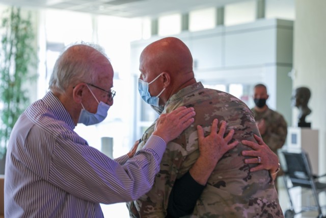 Command Sgt. Maj. Joshua Brown, senior enlisted adviser of the 76th Infantry Brigade Combat Team, hugs nurse Jackie Brames while Dr. Lawrence H. Einhorn embraces them. Brown was awarded the Legion of Merit at the Indiana University Health Cancer...