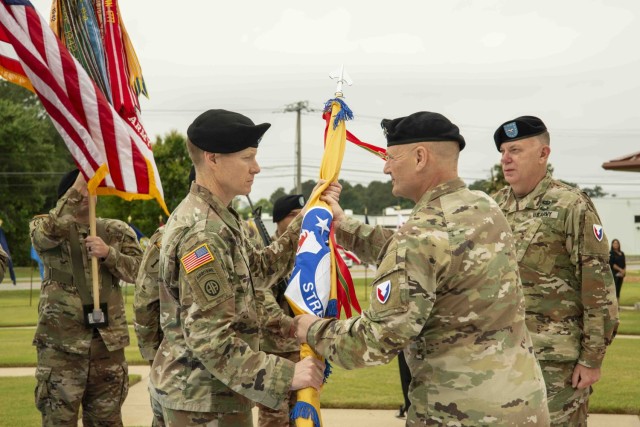 (From left) Colonel Jason Nicholson officially assumes command of USASAC as he accepts the unit colors from Army Materiel Command’s Gen. Ed Daly during a May 24, 2022 change of command ceremony at Redstone Arsenal. During the ceremony, Brig. Gen. Garrick Harmon relinquished command to Nicholson, who comes to USASAC after serving as the Chief of International Operations Division, G5, and the Deputy G5, U.S. Army Europe and Africa.