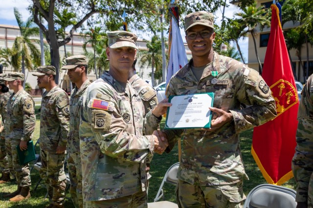 Brig. Gen. Holler presents Sgt. Clarke with an Army Commendation Model