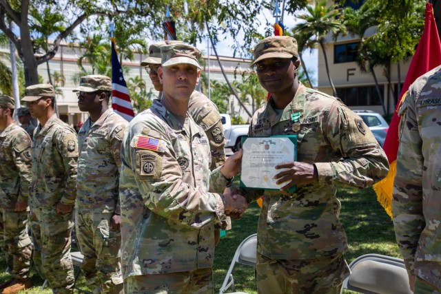 Brig. Gen. Holler presents Spc. Dotson with an Army Commendation Model
