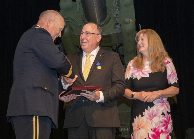 Acting Commanding General of the U.S. Army Futures Command, Lt. Gen. James M. “Jim” Richardson, presents John F. Hedderich III, director of the U.S. Army Combat Capabilities Development Command Armaments Center with the Department of the Army Distinguished Civilian Service Medal. Hedderich’s wife, Margaret “Maggie” Hedderich looks on.