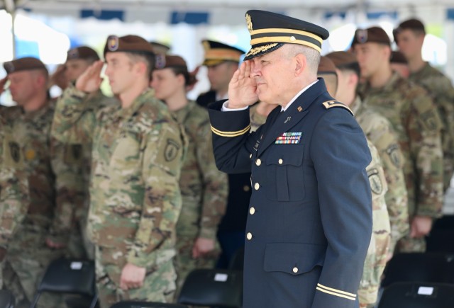 Chaplain (Maj.) Douglas Ochner, U.S. Army Garrison Japan, and other members of the community salute the fallen during a U.S. Army Japan Memorial Day ceremony on May 30, 2022, at Camp Zama, Japan.