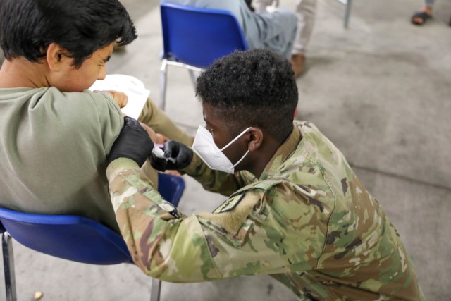 Afghan evacuees receive the Measles vaccine from 30th Medical Brigade, 21st Theater Sustainment Command personnel on Sept. 18, 2021, at Rhine Ordnance Barracks, Germany.