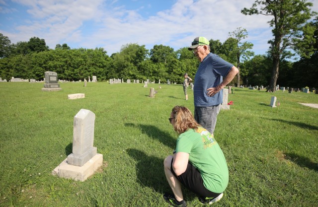 Families walk cemeteries at Fort Knox in search of relatives during Memorial Day visitation