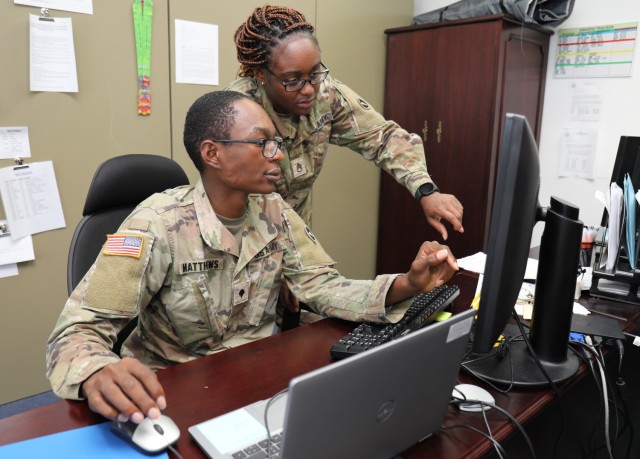 Spc. Antavius Matthews, left, a supply specialist assigned to the 35th Combat Sustainment Support Battalion, works on a task with Staff Sgt. Natasha Ridgeway, the supply sergeant, inside the unit supply room at Camp Zama, Japan, May 25, 2022. Matthews is one of many LGBTQ Soldiers who have been able to openly serve since 2011 after the repeal of the Defense Department’s “Don’t Ask, Don’t Tell” policy.
