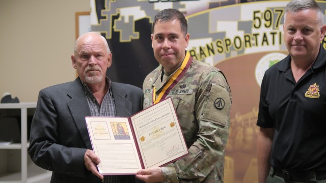  597th Transportation Brigade Operations Chief Lt. Col. Julio Reyes was inducted in to the Honorable Order of Saint Christopher by regimental member Larry Lawrence at Joint Base Langley-Eustis, Va. May 31.