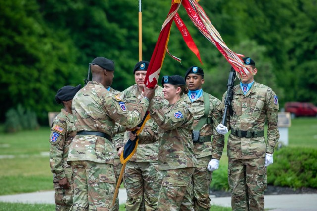 Col. Erin C. Miller, outgoing commander for the 10th Mountain Division Sustainment Brigade, passes the brigade colors to Maj. Gen. Milford H. Beagle, Jr., commanding general for the 10th Mountain Division, during the brigade Change of Command Ceremony May 31, 2022, at Memorial Park on Fort Drum, NY. During the ceremony, Miller relinquished command to Col. Fenicia L. Jackson. (U.S. Army photo by Spc. Anastasia Rakowsky)