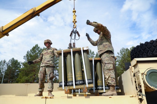 U.S. Army Spc. Jonathan Guernsey, left, and U.S. Army Spc. Khym Wilson, both assigned to the Forward Support Company, 119th Field Artillery Regiment, Michigan Army National Guard, guide the crane operator during Summer Shield at Forward Operating Site Adazi, Latvia, May 19, 2022. Summer Shield is one of U.S. Army Europe and Africa’s multinational training exercises in Eastern Europe that make up Defender Europe 22. (U.S. Army National Guard Photo by Sgt. Eliezer Meléndez)