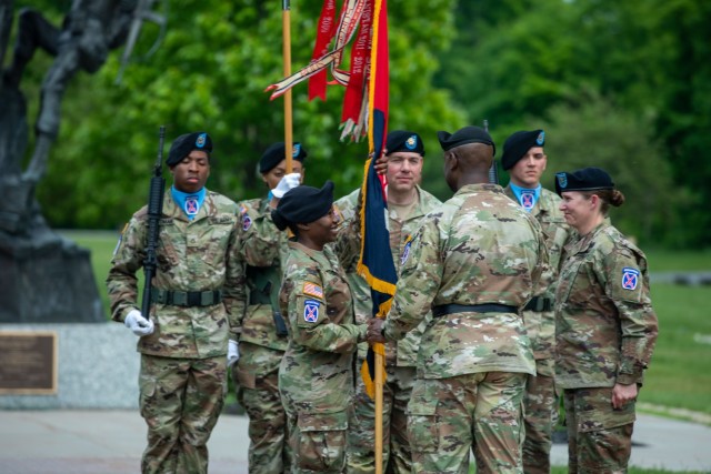 Maj. Gen. Milford H. Beagle Jr., commanding general for the 10th Mountain Division, passes the 10th Mountain Division Sustainment Brigade colors to Col. Fenicia L. Jackson, May 31, 2022, during the brigade’s change of command ceremony on May 31, 2022, at Memorial Park on Fort Drum, New York. During the ceremony, Col. Erin C. Miller relinquished command to Jackson. (U.S. Army Photos by Spc. Anastasia Rakowsky)
