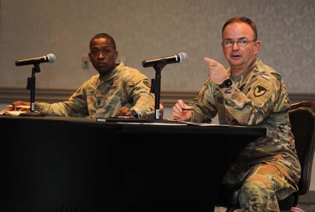 Col. Christopher L. Tomlinson, right, commander of U.S. Army Garrison Japan, and Command Sgt. Maj. Justin E. Turner, senior enlisted leader for USAG Japan, address questions during a quarterly town hall on housing at the Camp Zama Community Club, Japan, June 1, 2022. 