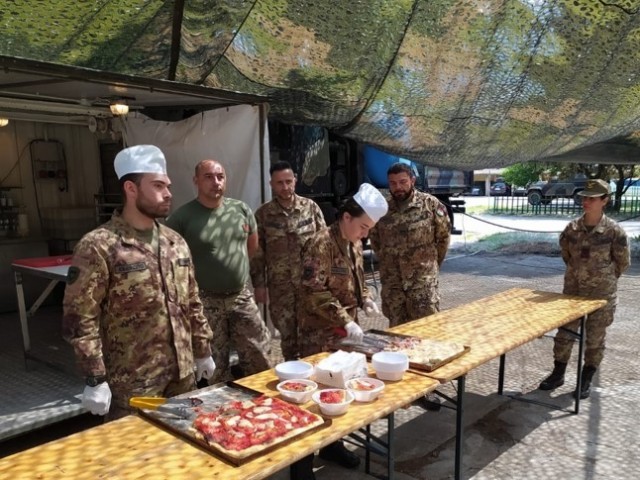 Italian soldiers from the “Julia” logistic regiment in Merano, Italy show their mobile pizza facility to U.S. members of the Logistics Readiness Center Italy, based out of Caserma Ederle on May 19. 