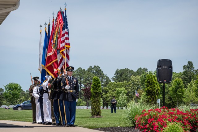 Fort Leonard Wood’s joint-service color guard stands at attention, awaiting the order to present the colors Monday during a Memorial Day ceremony at Missouri Veterans Cemetery - Fort Leonard Wood. 