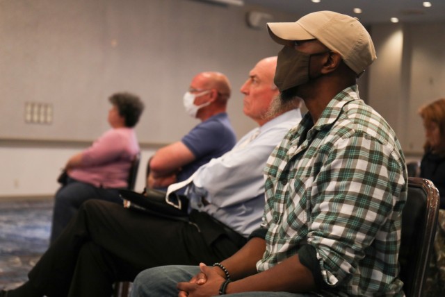 Audience members listen to a quarterly town hall on housing at the Camp Zama Community Club, Japan, June 1, 2022. 