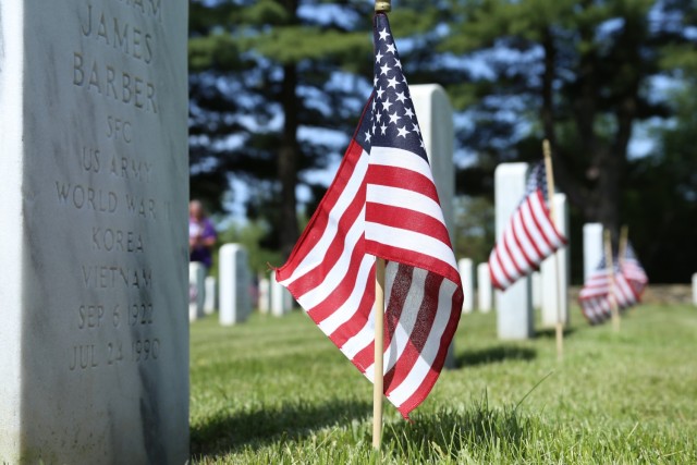 Flags adorn graves of fallen Veterans at Memorial Day ceremony